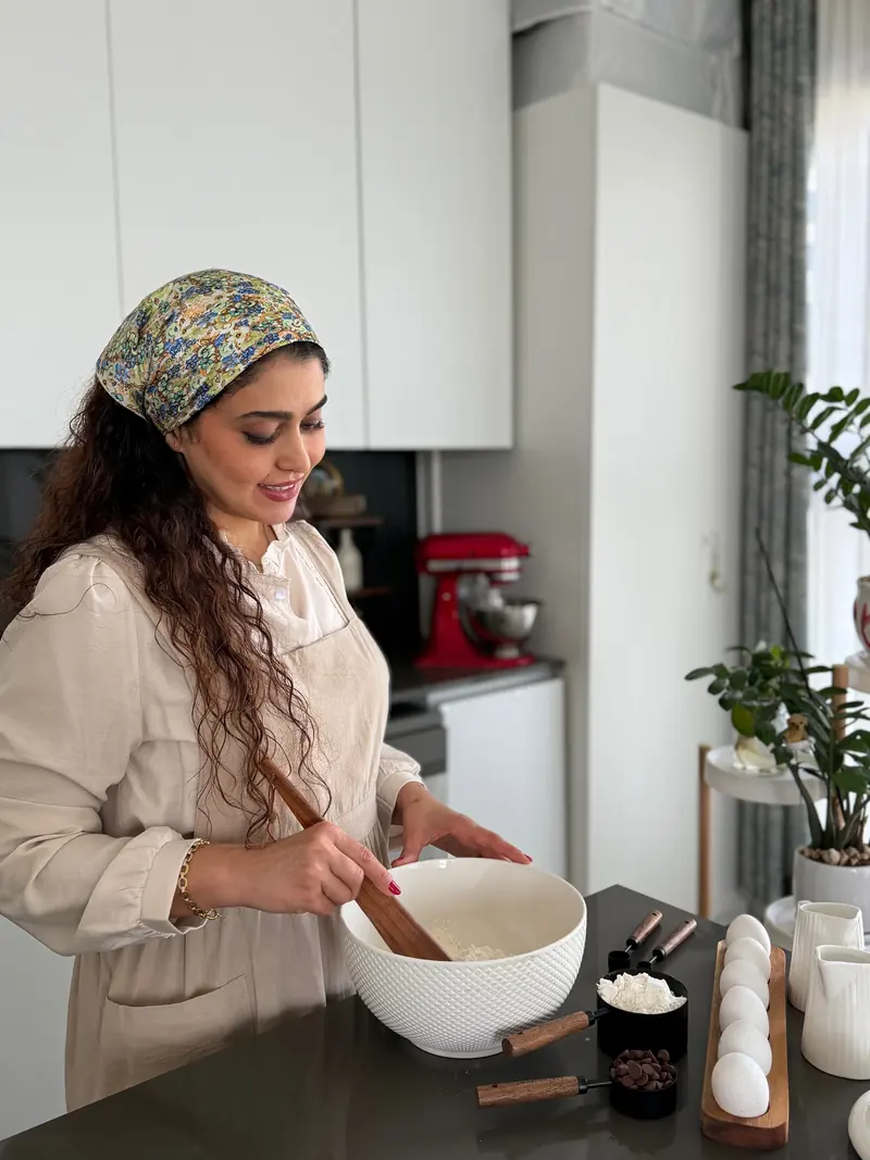 Nasi mixing batter in a white bowl with a wooden spoon